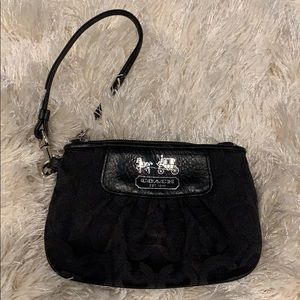 Black Coach wristlet with purple inside